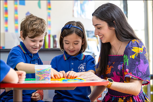 Students working with a teacher
