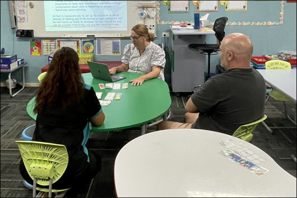 Teacher and parents meeting to support student learning.